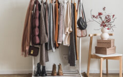 Women's seasonal autumn clothes on the floor hanger in the dressing room